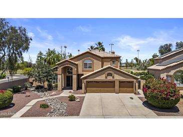 Charming two-story home with stucco exterior, three-car garage, and manicured front yard at 1244 W Straford Ave, Gilbert, AZ 85233