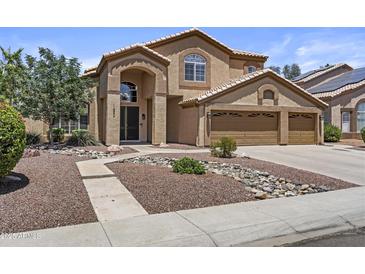 Charming two-story home with stucco exterior, three-car garage, and manicured front yard at 1244 W Straford Ave, Gilbert, AZ 85233