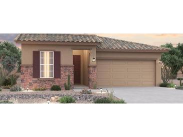 Charming single-story home featuring stone accents, a two-car garage, and low maintenance desert landscaping at 1365 S 215Th Ln, Buckeye, AZ 85326