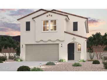 Charming two-story home with stucco siding, tile roof, and a two-car garage at 17223 W Daley Ln, Surprise, AZ 85387