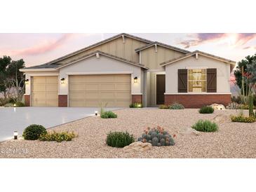 Charming single-story home featuring a three-car garage, desert landscaping, and beautiful architectural details at 17770 W Fulton St, Goodyear, AZ 85338