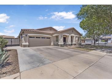 Charming single-story home with a well-manicured front yard and an attached two-car garage at 18998 E Lark Dr, Queen Creek, AZ 85142
