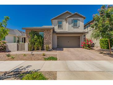Charming two-story home featuring a neutral color palette, brick accents, and a paved driveway at 22682 E Indiana Ave, Queen Creek, AZ 85142