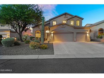 Charming two-story home featuring a three-car garage, desert landscaping, and classic Southwestern architecture at 3859 N El Sereno St, Mesa, AZ 85207