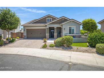 Charming single-story home featuring a lush landscaped yard and a welcoming two-car garage at 41465 W Sussex Dr, Maricopa, AZ 85138