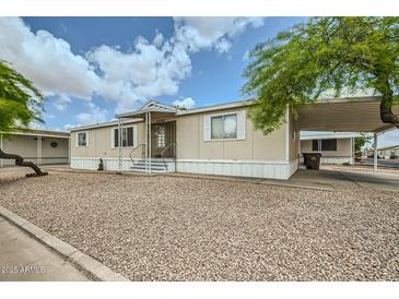 Charming single-story home featuring a covered carport and low maintenance landscaping at 9431 E Coralbell Ave # Ofc, Mesa, AZ 85208
