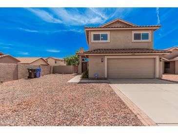 Front exterior of tan two-story home with red rock landscaping and driveway at 15440 S 38Th St, Phoenix, AZ 85044