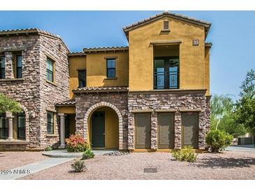 Attractive two-story townhouse with stone accents, an arched entryway, and a small balcony at 20750 N 87 St # 2103, Scottsdale, AZ 85255