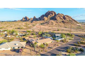 A stunning aerial shot captures a home set against a backdrop of desert and mountains with a nearby pool at 2319 N 58Th St, Scottsdale, AZ 85257