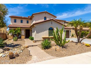 Stunning two-story home featuring desert landscaping with a tiled roof and charming curb appeal at 2460 E Crescent Way, Gilbert, AZ 85298