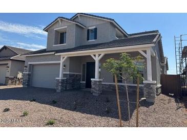 Beautiful two-story home featuring a covered porch and desert landscaping at 3811 S Bridlewood Ave, Mesa, AZ 85212