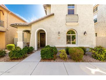 Charming home exterior featuring stucco, arched entry, and well-maintained landscaping at 3910 E Turley St, Gilbert, AZ 85295