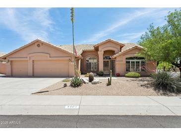 Charming single-story home with a three-car garage, desert landscaping, and a tiled roof at 4401 E Barwick Dr, Cave Creek, AZ 85331