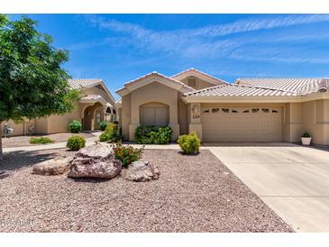 Charming single-story home featuring a desert landscape, tile roof and an attached two-car garage at 5830 E Mckellips Rd # 120, Mesa, AZ 85215