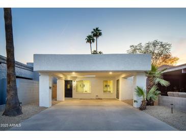 Charming home featuring a covered carport, desert landscaping, and a stylish front door at 628 N Hobson --, Mesa, AZ 85203