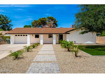 Charming single-story home with desert landscaping, brick pathway, and white pillars at 1304 W Ocotillo Rd, Phoenix, AZ 85013