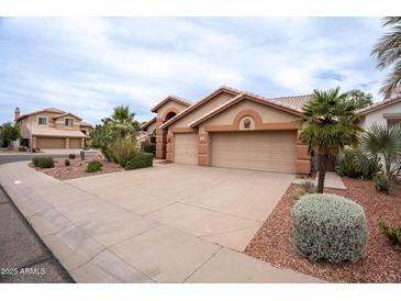 Charming single-story home featuring a three-car garage, desert landscaping, and neutral color palette at 15809 S 31St St, Phoenix, AZ 85048