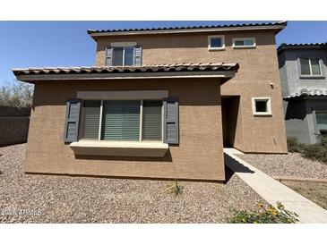Tan two-story home showing front entrance and landscaped ground cover at 1725 W Pollack St, Phoenix, AZ 85041