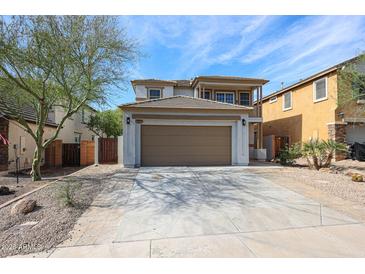 Charming two-story home features a two-car garage and desert landscaping at 29270 W Weldon Ave, Buckeye, AZ 85396