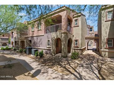 Beautiful townhome featuring stucco finish, balcony, gated entrance, and low maintenance landscaping at 3935 E Rough Rider Rd # 1164, Phoenix, AZ 85050
