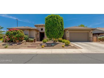 Stunning single-story home featuring desert landscaping, a two-car garage, and a welcoming front entrance at 5085 S Ponderosa Dr, Gilbert, AZ 85298