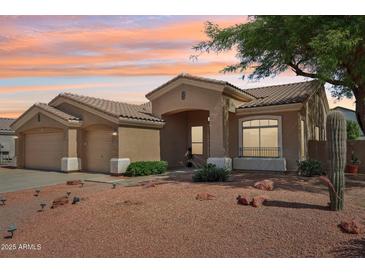 Charming single-story home with a well-manicured desert landscape and neutral color palette at 6781 W Lone Cactus Dr, Glendale, AZ 85308