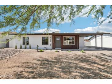 Charming single-story home featuring a desert landscape and covered parking at 1653 E Palmcroft Dr, Tempe, AZ 85282