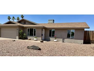 Charming single-story home boasts desert landscaping, a two-car garage, and a cozy front porch entrance at 1661 E Bishop Dr, Tempe, AZ 85282