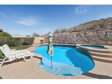 Stunning backyard pool and spa with beautiful desert landscape views at 18121 W Las Cruces Dr, Goodyear, AZ 85338