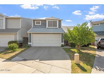 Two-story home with blue siding, white garage door, and well-maintained front yard at 18644 N 5Th Ave, Phoenix, AZ 85027
