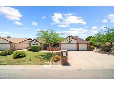 Charming single-story home with brick accents, well-maintained landscaping, and a two-car garage at 4353 W Villa Rita Dr, Glendale, AZ 85308
