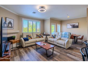 Cozy living room with plush seating, modern lighting, and a fireplace for relaxed living at 5345 E Van Buren St # 307, Phoenix, AZ 85008