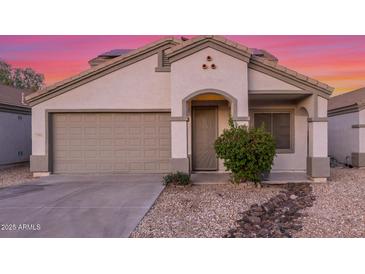 Charming single-story home with a two-car garage, desert landscaping, and neutral color palette at 7319 S 56Th Dr, Laveen, AZ 85339