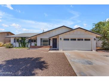 Charming single-story home featuring a well-maintained front yard and attached garage at 1020 E Concorda Dr, Tempe, AZ 85282