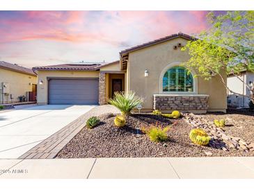 Charming single-story home features desert landscaping, a stone facade, a tile roof, and a two-car garage at 13448 W Miner Trl, Peoria, AZ 85383
