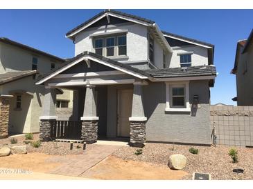 Charming two-story home with a covered front porch and stone accents on the pillars at 13489 N 158Th Ave, Surprise, AZ 85379
