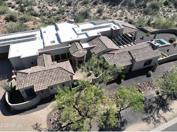 Expansive estate showcasing desert landscaping, tiled roofs, private pool and spa, offering a luxurious outdoor experience at 13931 E Via Linda --, Scottsdale, AZ 85259