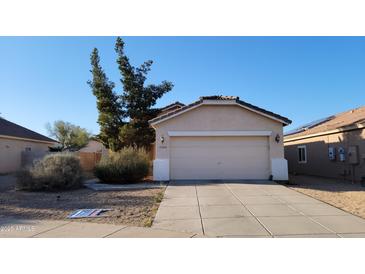 Charming single-level home with a two-car garage, desert landscaping, and tile roof at 15364 W Acapulco Ln, Surprise, AZ 85379