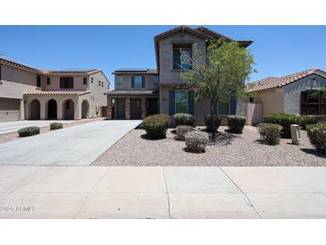 Two-story home featuring desert landscaping, covered parking, and solar panels for energy efficiency at 16475 N 183Rd Dr, Surprise, AZ 85388