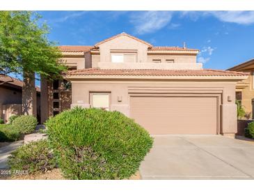 Charming two-story home featuring a tile roof and well-maintained landscaping at 22063 N 77Th St, Scottsdale, AZ 85255