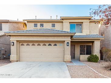 Two-story home with a two-car garage, desert landscaping, and neutral colored stucco at 22500 N Greenland Park Dr, Maricopa, AZ 85139