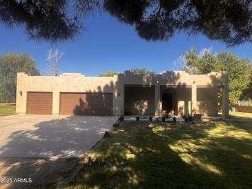 Charming single-story home with a stucco exterior, three-car garage, and well-maintained landscaping at 25722 S 179Th St, Queen Creek, AZ 85142