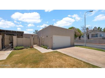 Charming home featuring a private gate, attached garage, and well-maintained front yard at 3345 E University Dr # 47, Mesa, AZ 85213