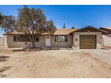Charming single-story home featuring a tan exterior, tidy landscaping, and a single-car garage at 3562 W Seldon Ln, Phoenix, AZ 85051