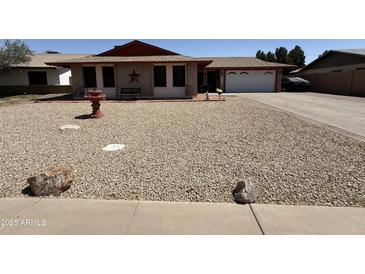 Charming single-story home with low-maintenance landscaping and a welcoming entrance at 1557 W Posada Ave, Mesa, AZ 85202