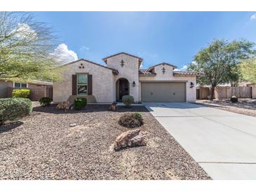 Charming single-story home featuring desert landscaping, a two-car garage, and covered entry at 18149 W Turney Ave, Goodyear, AZ 85395