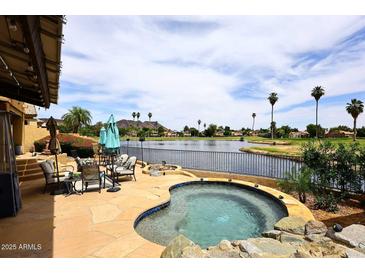 Enjoy this backyard with a private spa overlooking a lake and golf course at 21609 N 61St Ave, Glendale, AZ 85308