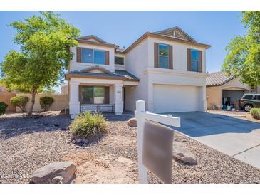 Charming two-story home with a well-manicured front yard and inviting curb appeal, painted in an attractive neutral color at 2847 S 161St Dr, Goodyear, AZ 85338