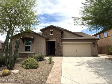Charming single-story home featuring a stone facade, two-car garage, and desert landscaping at 3721 W Aracely Dr, New River, AZ 85087