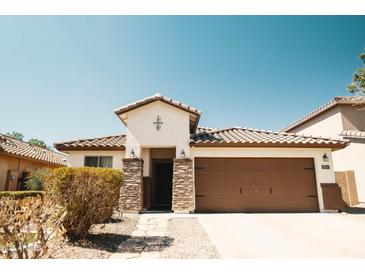 Charming single-story home features a neutral color scheme and well-maintained front yard and desert landscaping at 3756 E Alamo St, San Tan Valley, AZ 85140